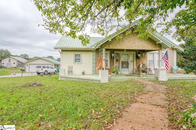 view of front of house with a front yard and covered porch