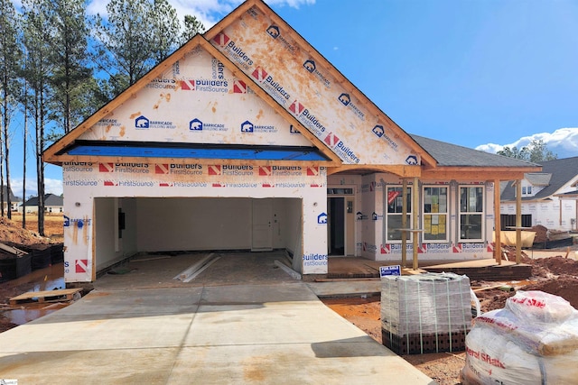 unfinished property with a garage and driveway