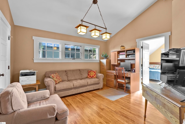 living room featuring vaulted ceiling and light hardwood / wood-style flooring