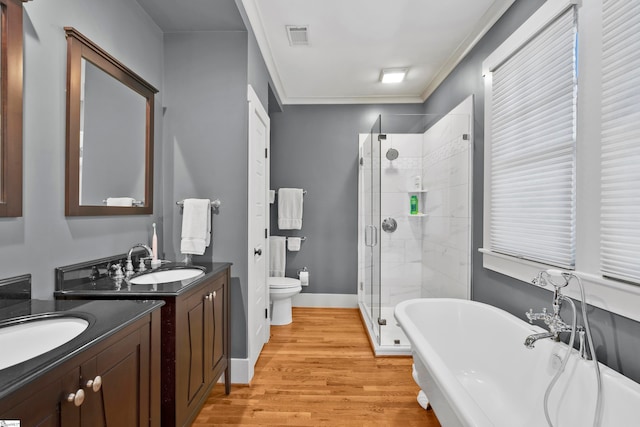 full bathroom featuring ornamental molding, hardwood / wood-style floors, vanity, and plus walk in shower