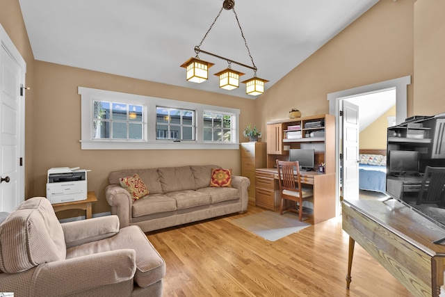 living room with vaulted ceiling and light hardwood / wood-style flooring