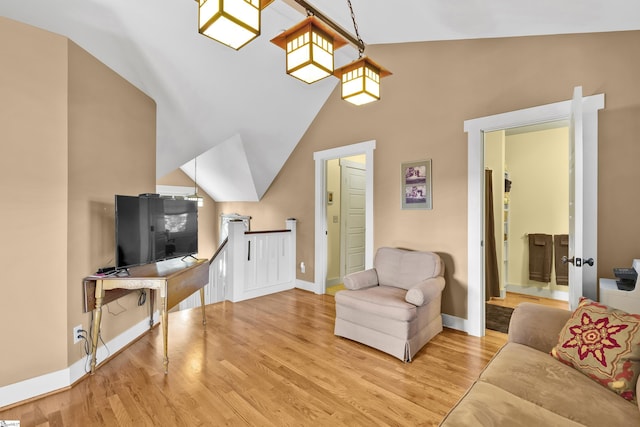 living room with lofted ceiling and light wood-type flooring