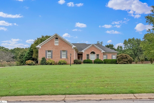 view of front of house with brick siding and a front yard