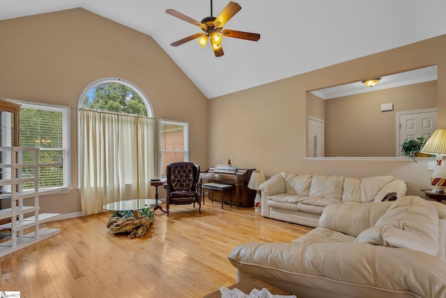 living area featuring light wood-type flooring, ceiling fan, and high vaulted ceiling