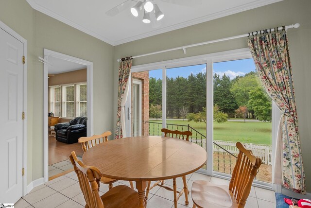 dining area with a ceiling fan, light tile patterned floors, and ornamental molding