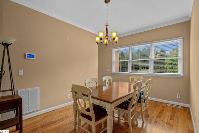 dining space featuring visible vents, a chandelier, and light wood-type flooring