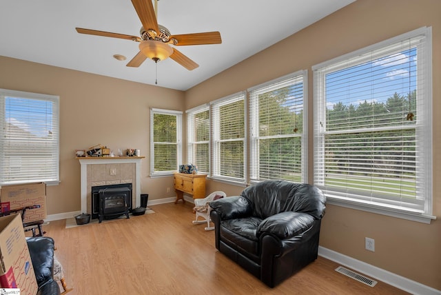 living area with visible vents, baseboards, and wood finished floors
