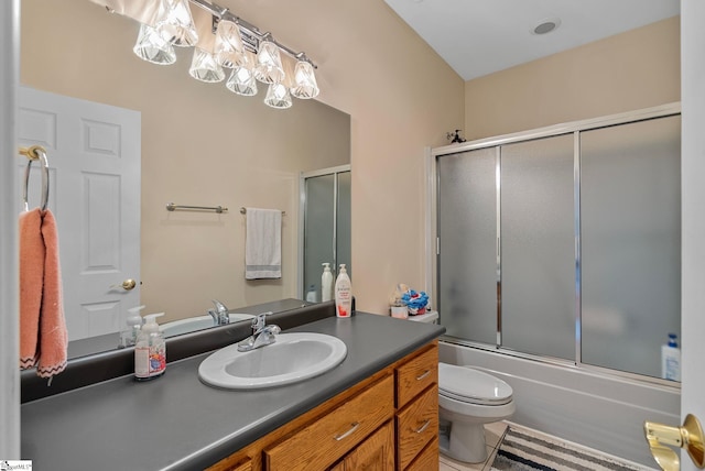 full bathroom featuring toilet, tile patterned flooring, shower / bath combination with glass door, and vanity