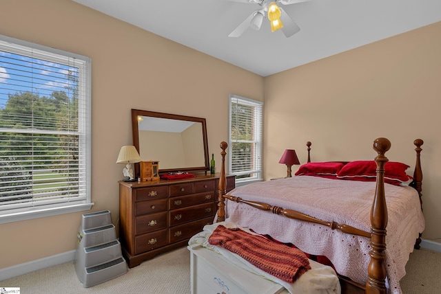 bedroom featuring baseboards, light carpet, and ceiling fan