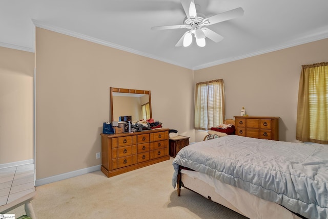 carpeted bedroom with crown molding, baseboards, and ceiling fan