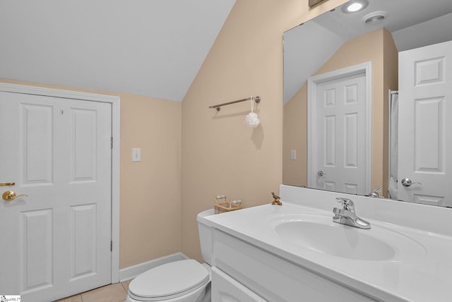bathroom featuring vanity, toilet, baseboards, tile patterned floors, and vaulted ceiling
