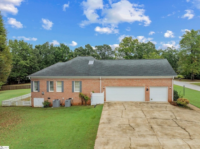 colonial home featuring concrete driveway, a shingled roof, and a front yard