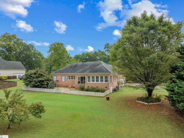 back of house with a yard, fence, and central AC unit