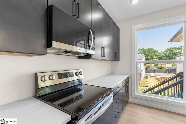 kitchen featuring appliances with stainless steel finishes and light hardwood / wood-style flooring