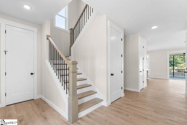 staircase with wood-type flooring