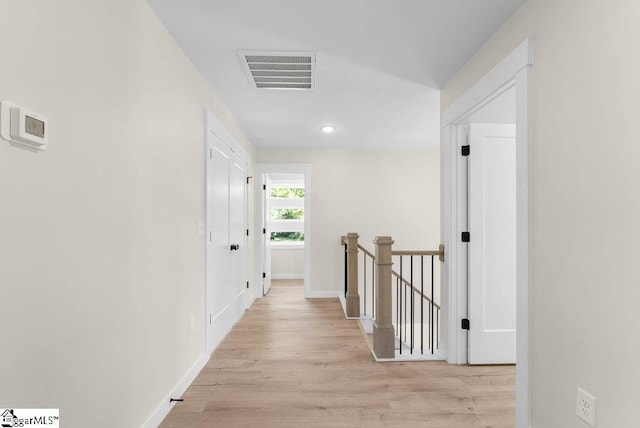 corridor with light wood-type flooring