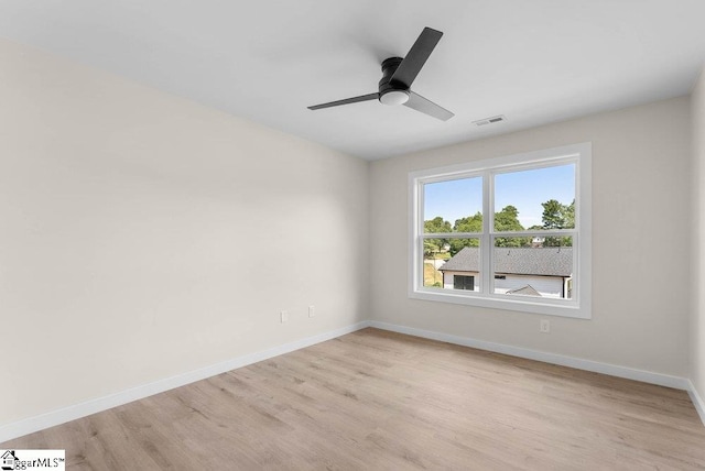 spare room with light wood-type flooring and ceiling fan