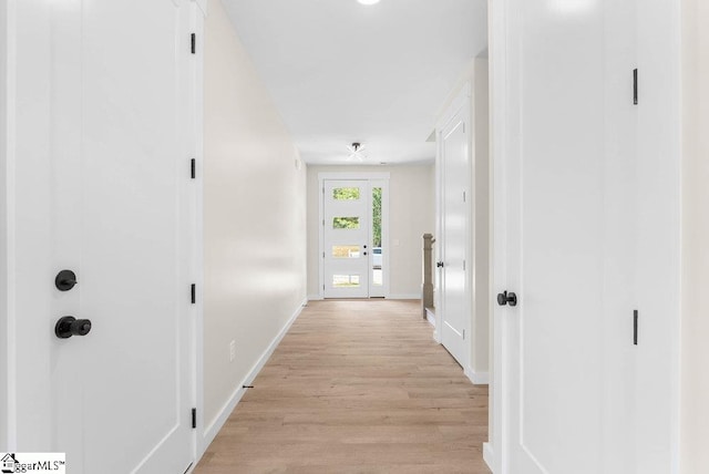 corridor with light wood-type flooring