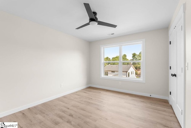 unfurnished bedroom with ceiling fan and light wood-type flooring