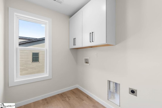 washroom with cabinets, hookup for an electric dryer, washer hookup, and light hardwood / wood-style flooring