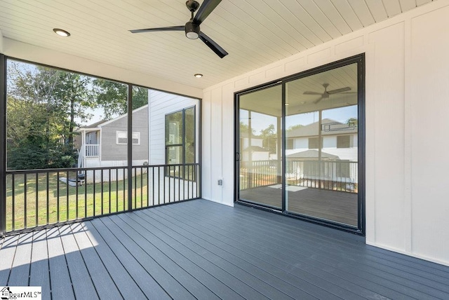 wooden deck featuring a yard and ceiling fan