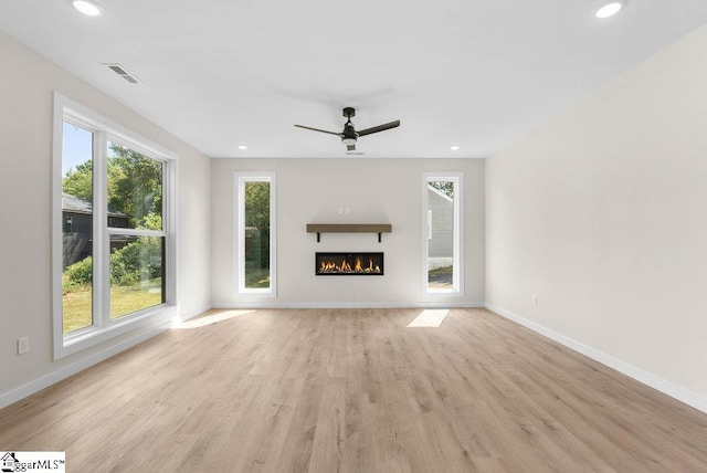 unfurnished living room with light hardwood / wood-style floors and ceiling fan