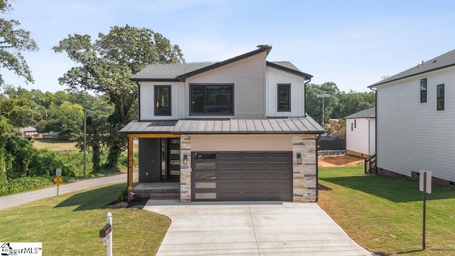 view of front of home with a garage and a front lawn