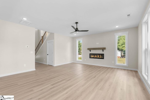 unfurnished living room with ceiling fan and light hardwood / wood-style flooring