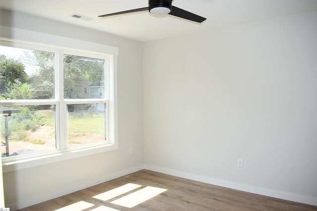 unfurnished room with ceiling fan, light wood-type flooring, and plenty of natural light