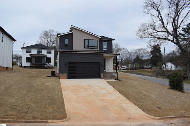 contemporary house with concrete driveway, metal roof, an attached garage, a standing seam roof, and board and batten siding