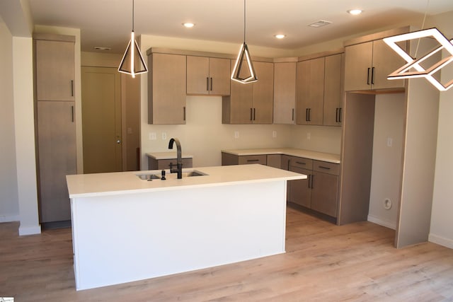 123 Jackson St, Greer, SC 29650 - kitchen with a sink, a kitchen island with sink, baseboards, light wood finished floors, and recessed lighting