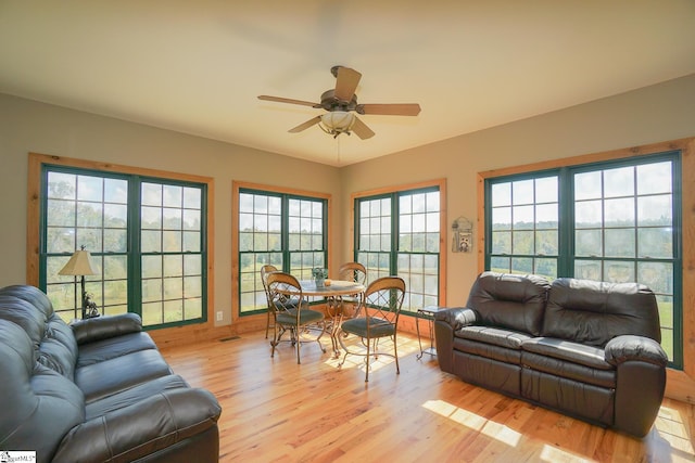 living room with ceiling fan, light hardwood / wood-style flooring, and plenty of natural light