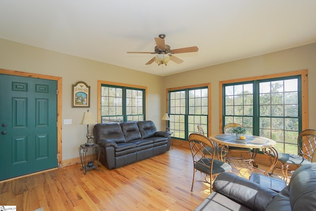 living room featuring ceiling fan, light wood-type flooring, and a healthy amount of sunlight