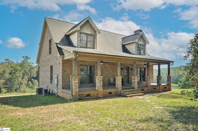 new england style home with cooling unit, a front yard, and a porch