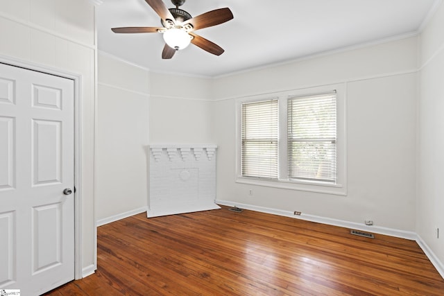 spare room with ceiling fan, hardwood / wood-style flooring, and crown molding