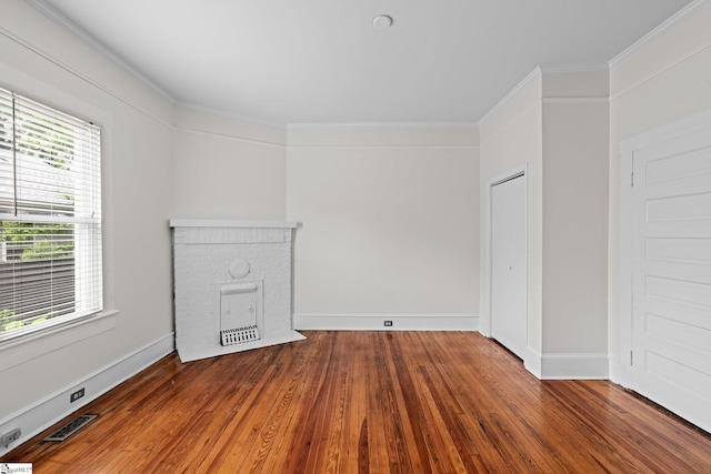 unfurnished living room with crown molding and hardwood / wood-style floors