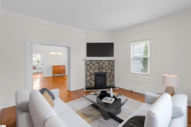 living room with hardwood / wood-style flooring, a fireplace, and a wealth of natural light