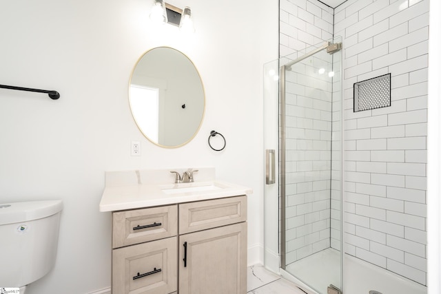 bathroom with vanity, a shower with shower door, and toilet