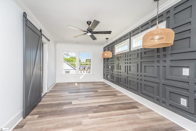 view of property's community featuring ceiling fan and a barn door