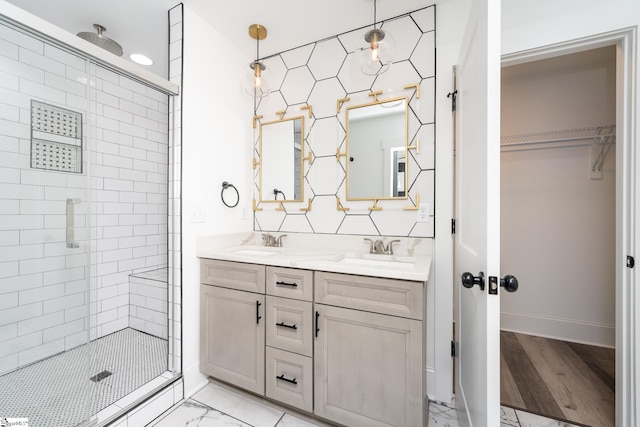 bathroom with wood-type flooring, vanity, and an enclosed shower