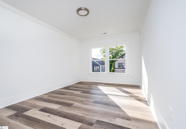 unfurnished room featuring crown molding and hardwood / wood-style flooring