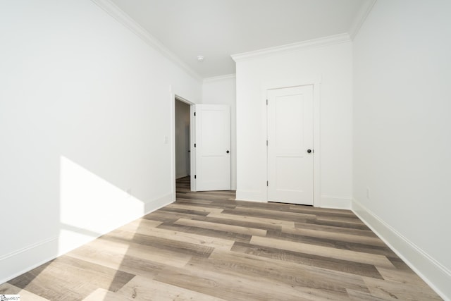 spare room featuring ornamental molding and hardwood / wood-style flooring