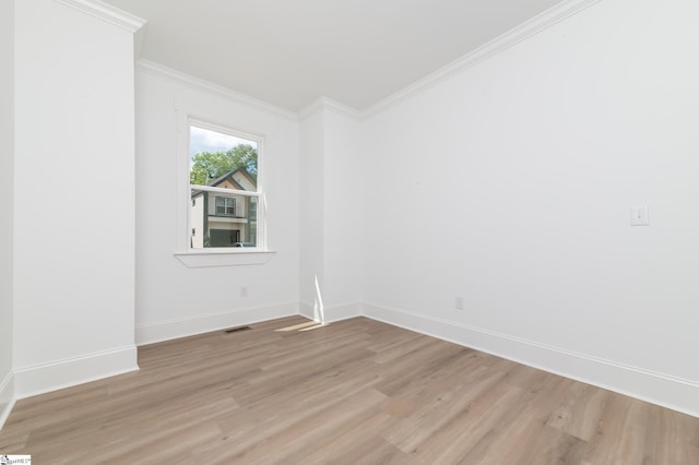 unfurnished room with light hardwood / wood-style floors and ornamental molding