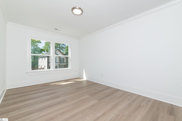 spare room with crown molding and light hardwood / wood-style floors