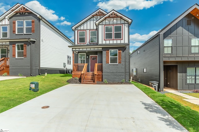 view of front facade featuring board and batten siding and a front lawn