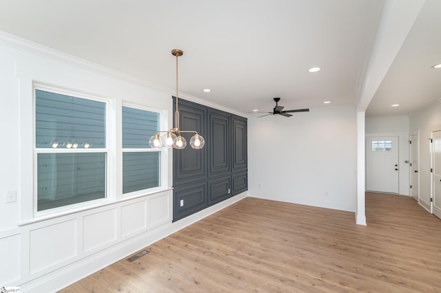 spare room with ceiling fan, hardwood / wood-style flooring, and crown molding