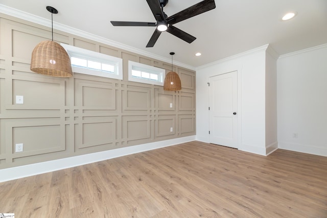 spare room featuring ceiling fan, light hardwood / wood-style flooring, and crown molding