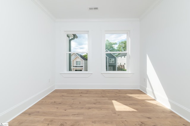 unfurnished room with light hardwood / wood-style flooring and ornamental molding