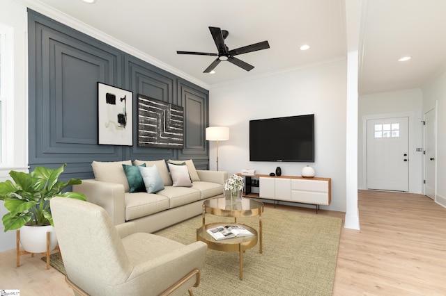 living area with light wood-type flooring, ornamental molding, a ceiling fan, and recessed lighting