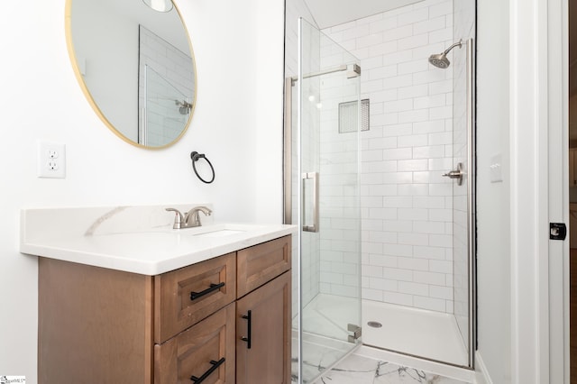 bathroom with walk in shower and vanity